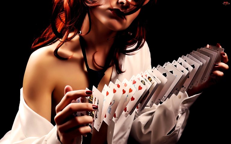A red-haired girl with a deck of cards in her hands