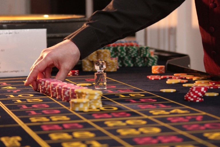 stacks of casino chips on a roulette table