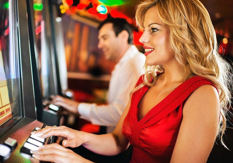 girl in red playing casino slot