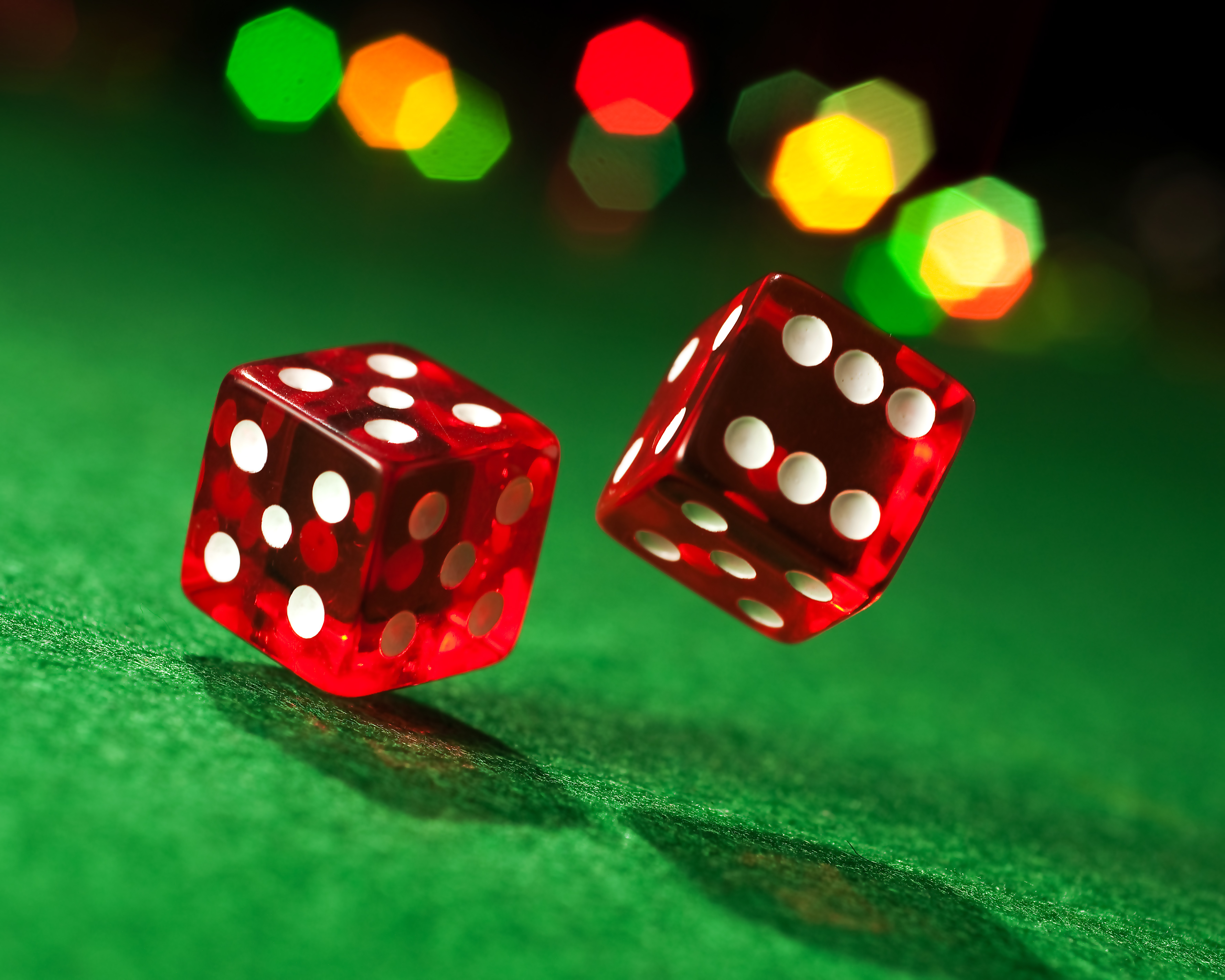 red dice Red dice on a green background